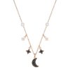 A close-up of the Swarovski Symbolic Moon Necklace, showcasing a rose-gold tone chain with a shimmering moon pendant and star charms, adorned with black and white crystals. 